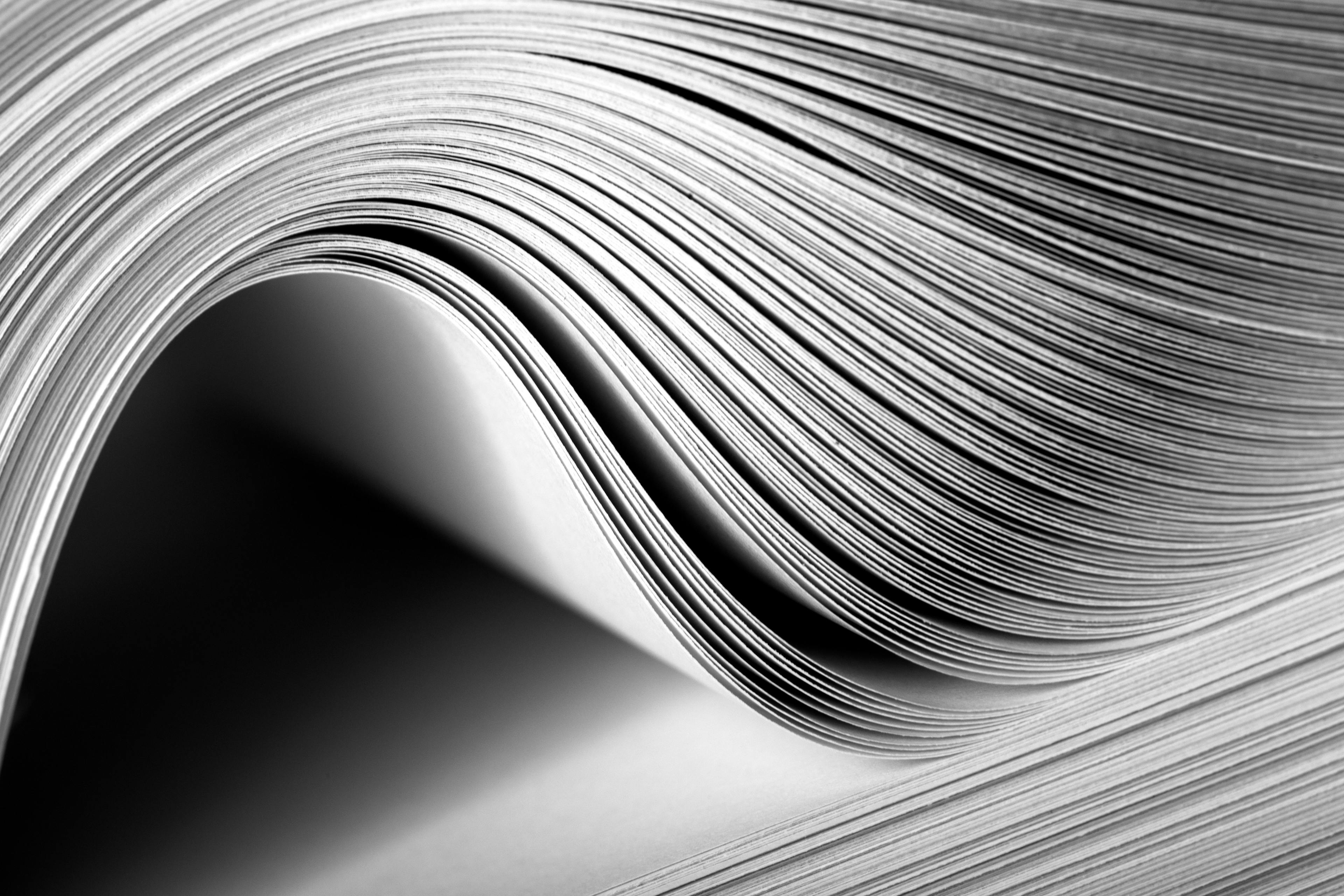 Close up of a large book or magazine lying open in black and white