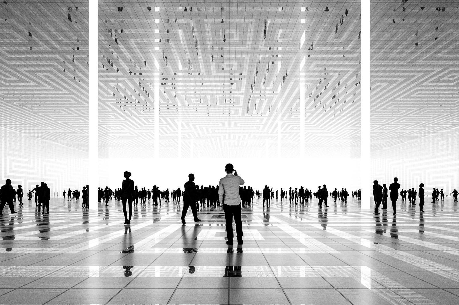 People walking in a modern building with decorative ceiling